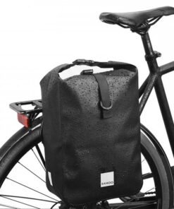 Sacoche de vélo noire 10L étanche installée sur porte-bagage arrière et portée en bandoulière
